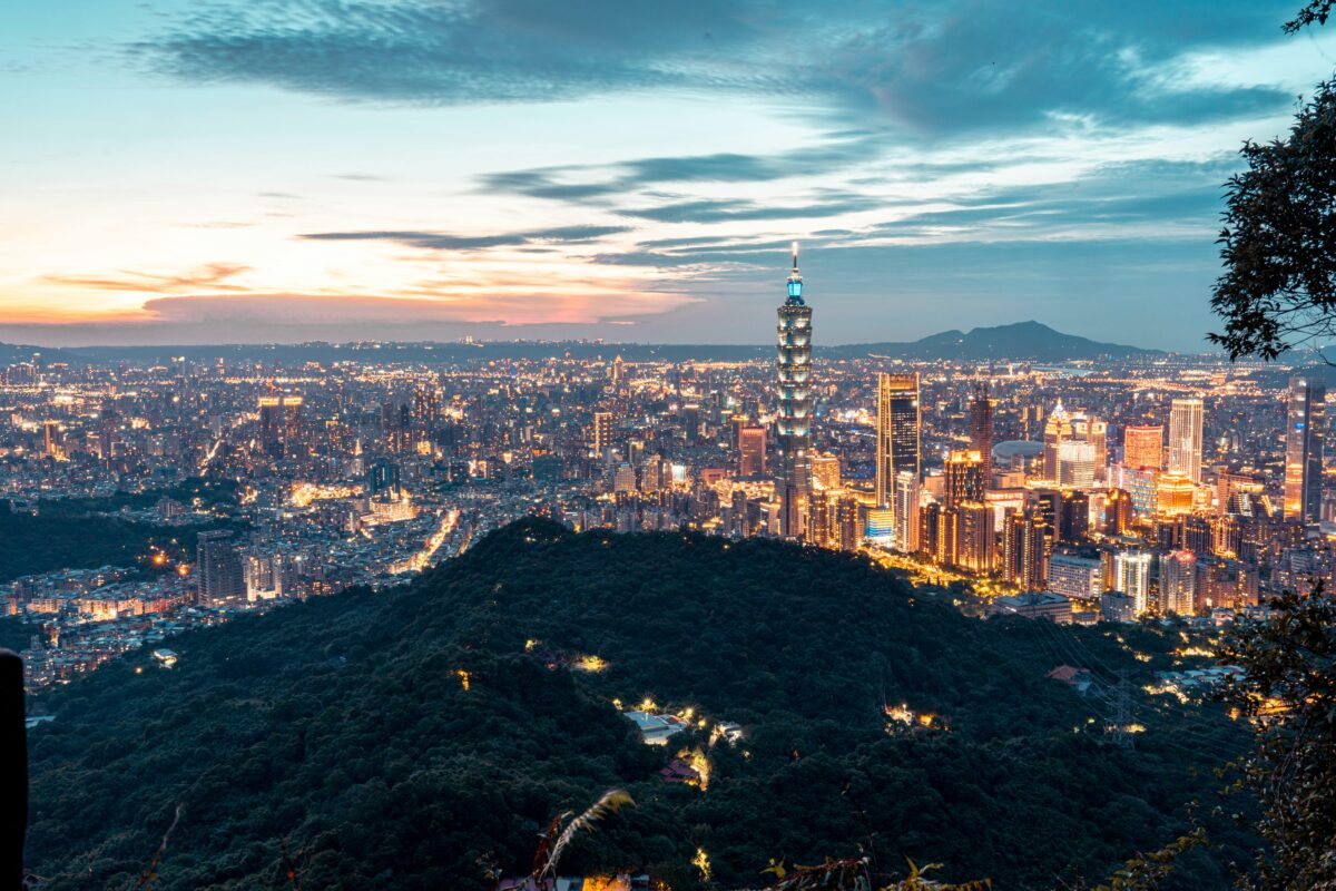 Vibrant Taipei cityscape featuring illuminated Taipei 101 during twilight.